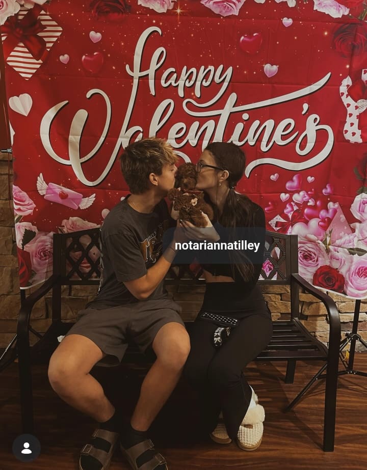 Image - NicoTooSwift, is pictured with his girlfriend & soon-to-be wife, Cora Tilley, back in January 2026, with their newest pet dog. 