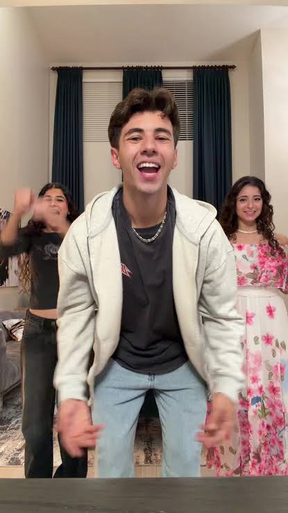 Image - Angelo Bahu, is pictured doing a TikTok dance trend with her two sisters; older sister, Alyssa Bahu, and younger sister, Mariah Bahu.